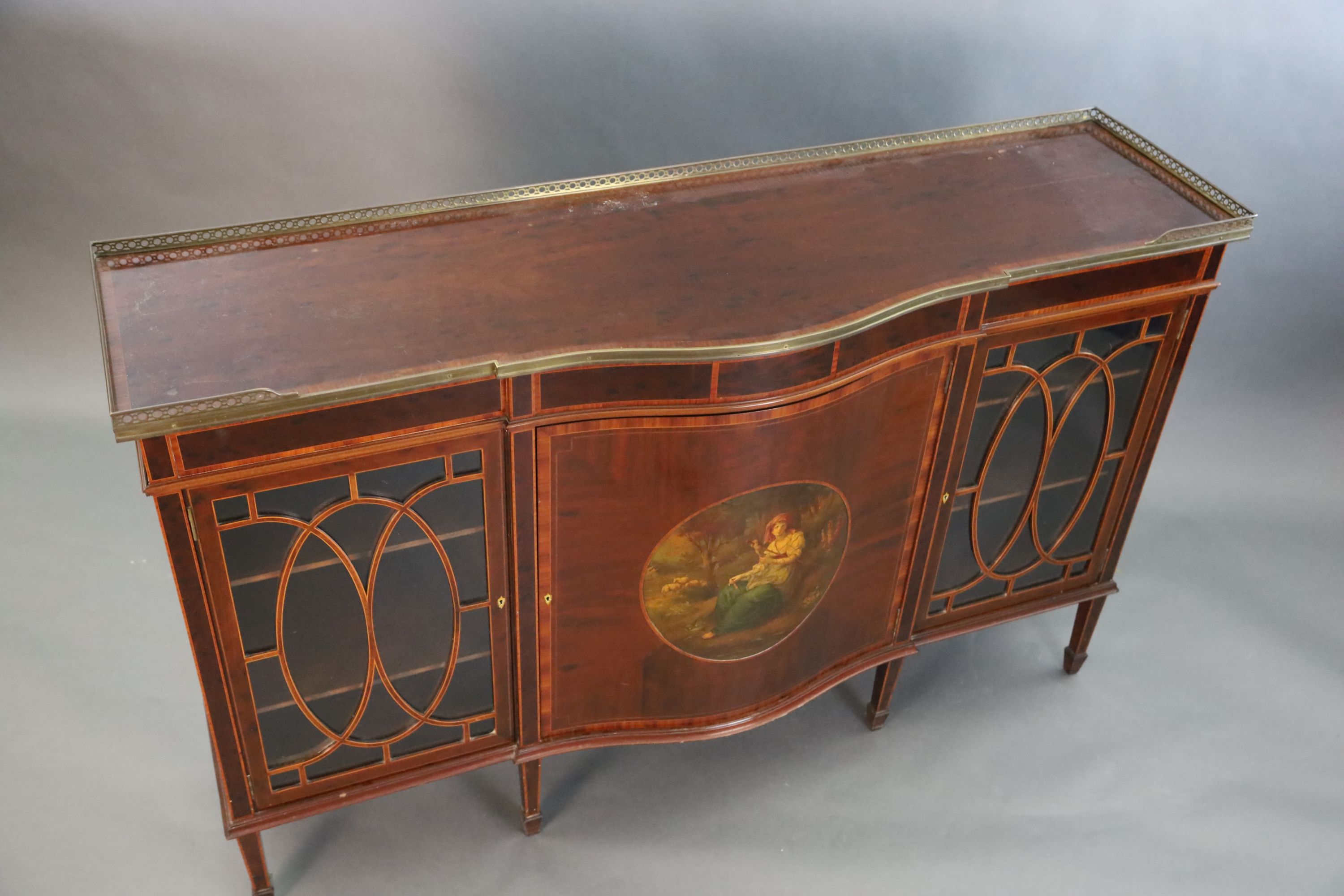 An Edwardian rosewood banded mahogany serpentine dwarf bookcase, W.5ft 1.5in. D.1ft 6in. H.3ft 3in.
